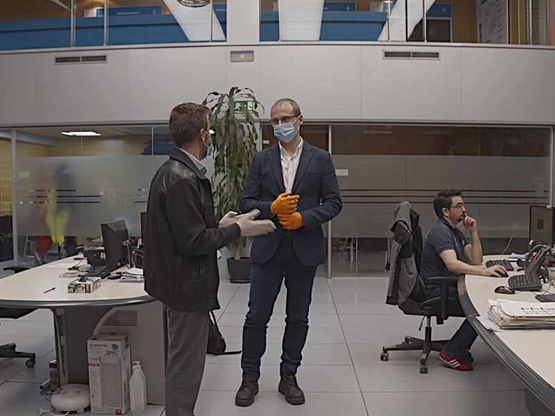 Image of workers wearing PPE in an office, during Covid-19.
