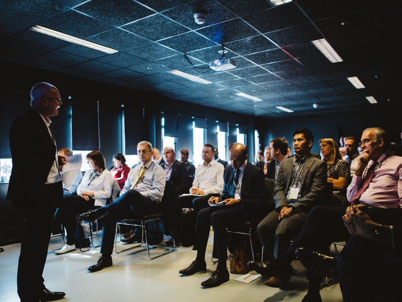 Image of a man presenting to an audience. 