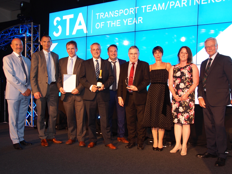 Group image of Amey employees holding an award.