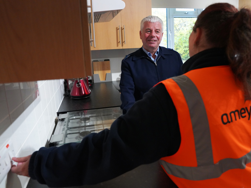 Image two two Amey employees, stood in a kitchen area.