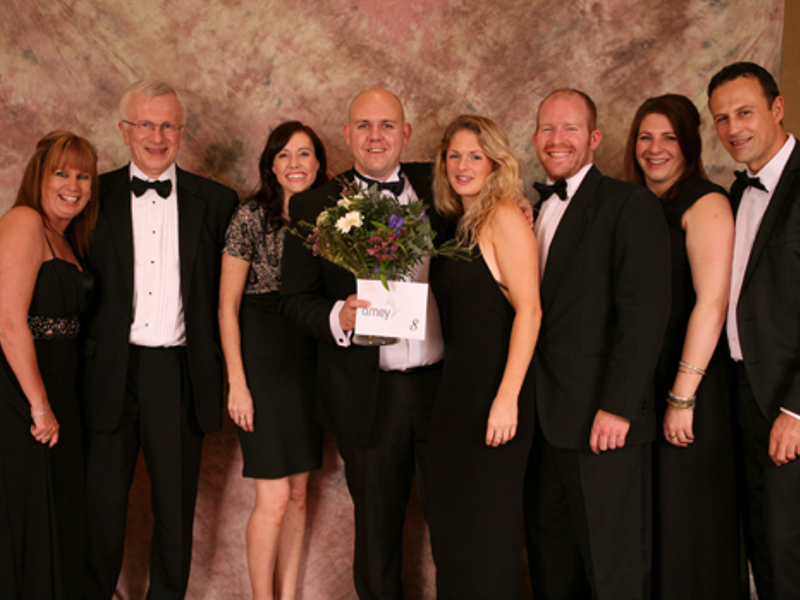 A group of men and women in formal attire.