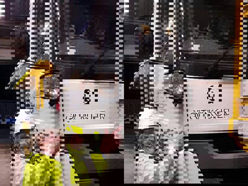 Amey employee stood next to a gritter.