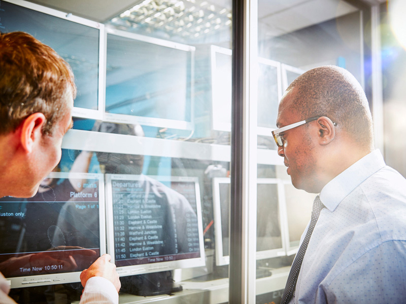 Two men looking at a departure board