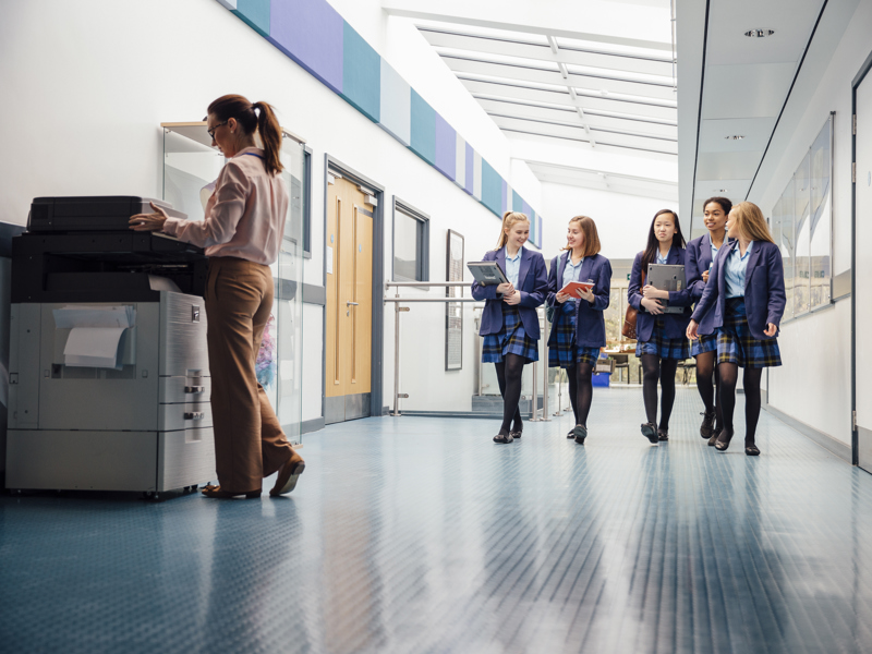 Children walking down a school corridor. 