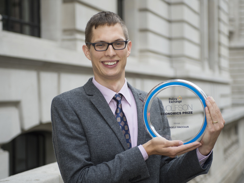 a man holding an award.