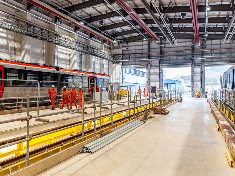 Image of a contruction site within a train station, with multiple Amey employees working