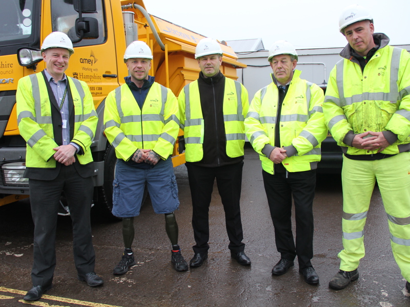 Image of men in PPE, stood in front of an  Amey recycling van.