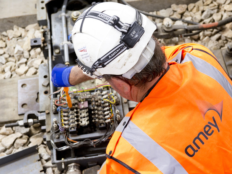 Amey employee carrying out rail maintanance. 
