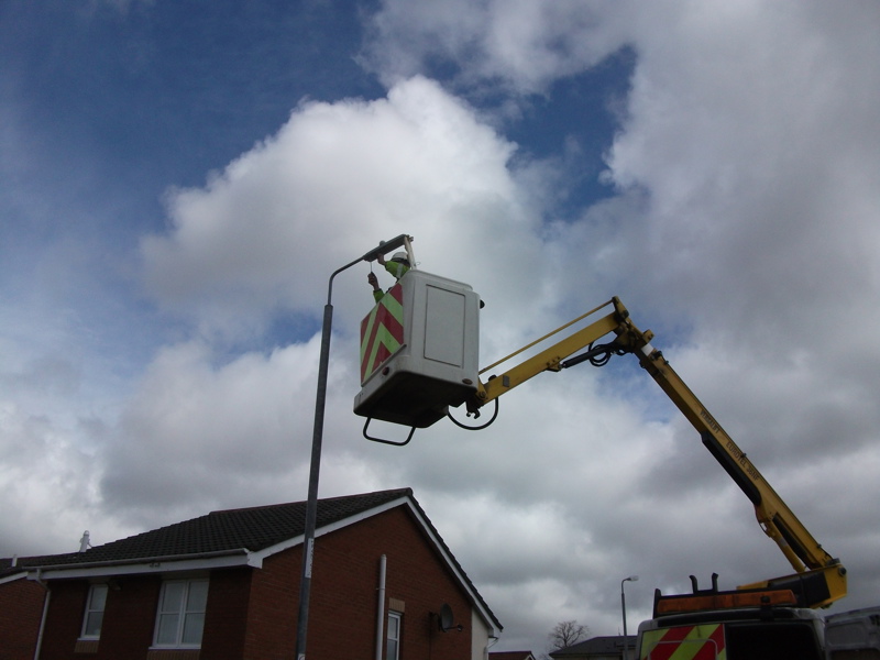 a man repairing a streetlight.