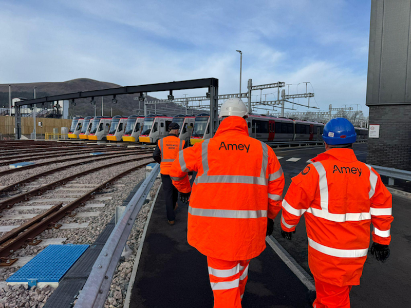 Two people in Amey PPE on a rail track