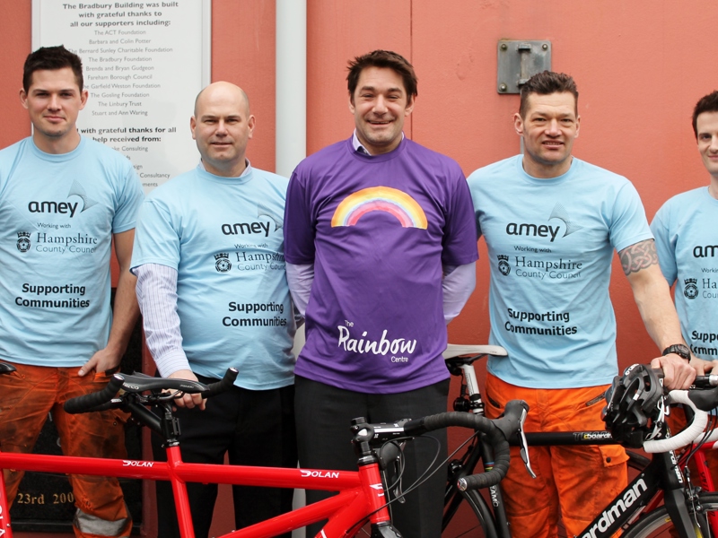 Amey and Rainbow centre employees, stood in front of two bicycles. 