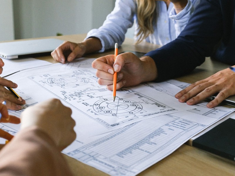 Image of people working on a document.