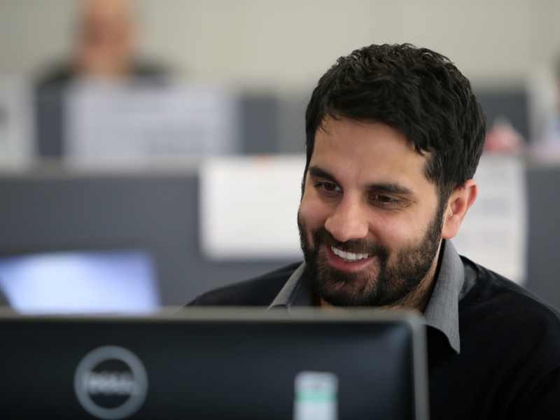 Image of a man sat in front of a laptop.