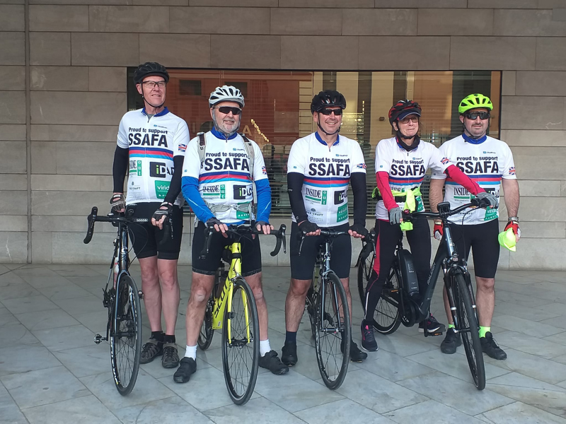Image of five men in cycling gear on bikes.