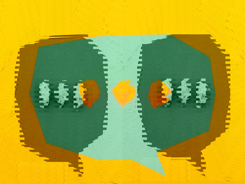 A green speech mark made out of paper. 