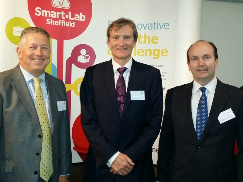 Three men stood side by side in formal attire.