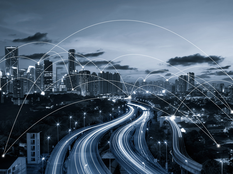 Image of a city, with curved lines pin pointing buildings.