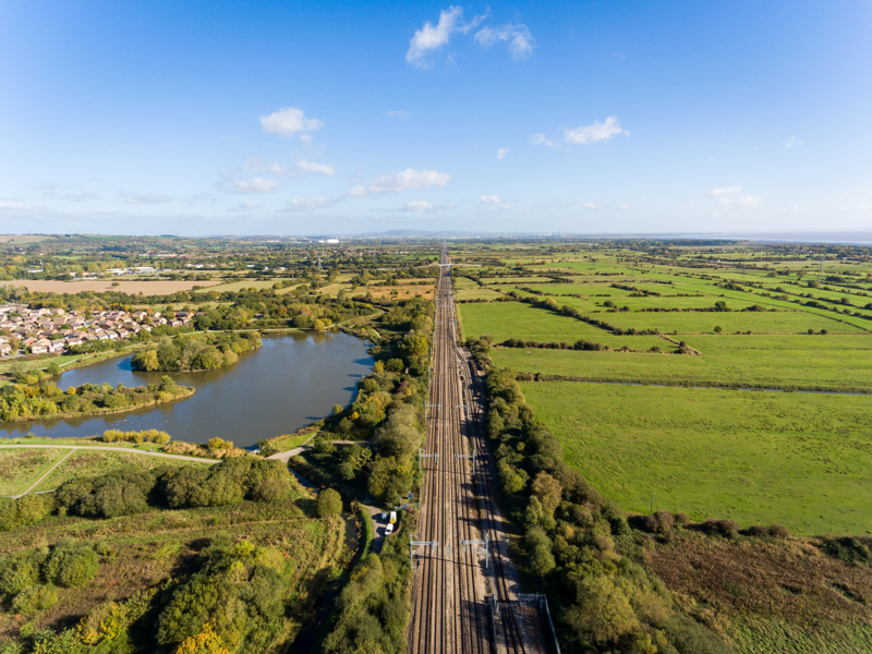 image of a rail track in the countryside taken from a height