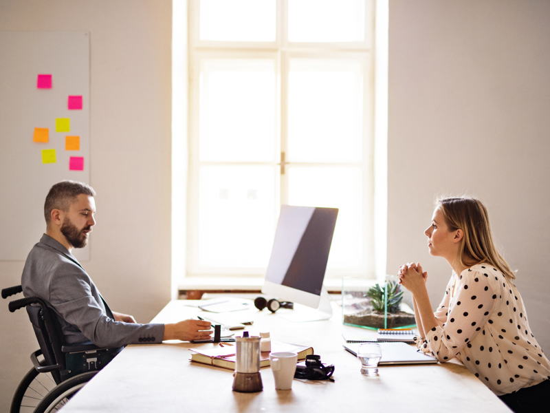 man and women sat either side of a desk