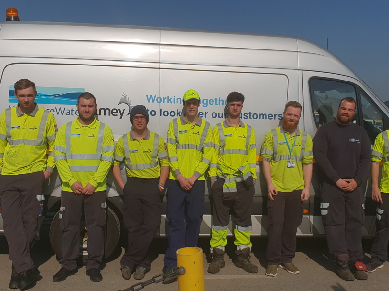 Group of Amey employees in PPE, stood in front of a van.