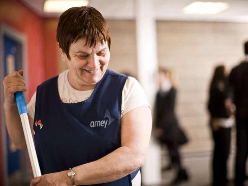 Image of an Amey cleaner mopping the floor.