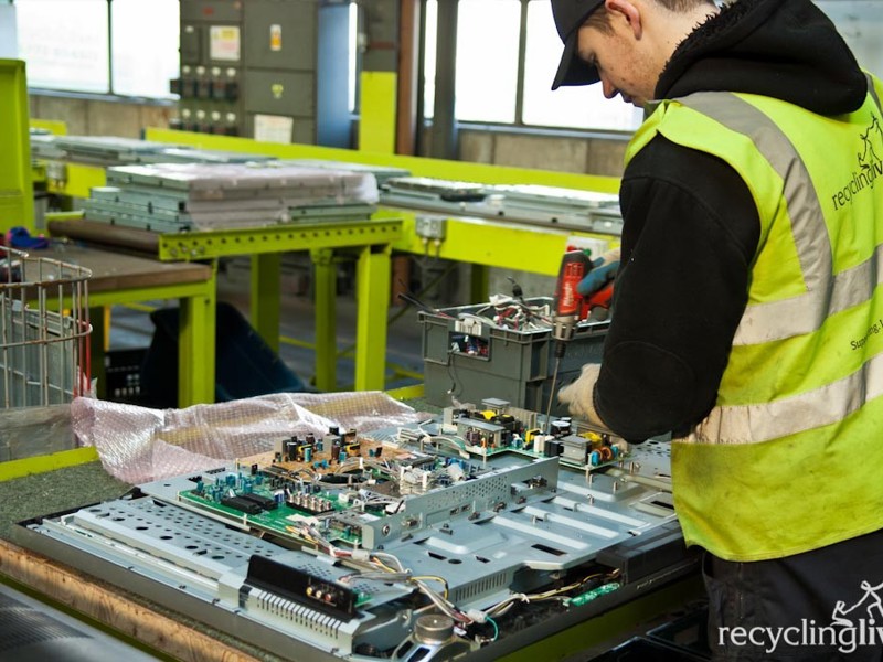 Amey employee working on a circuit board.