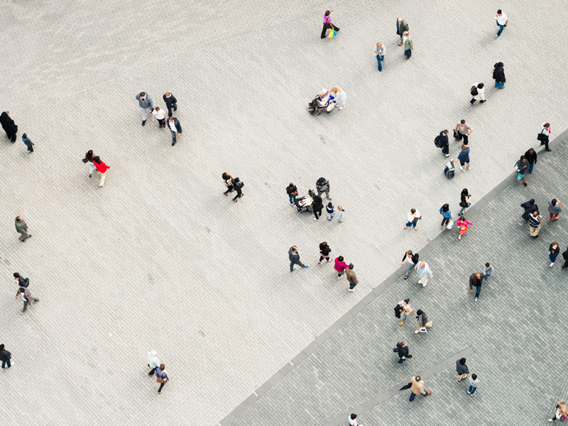 ariel image of people walking on a pavement.