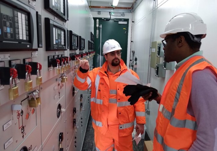 Two Amey employees working within a control room.