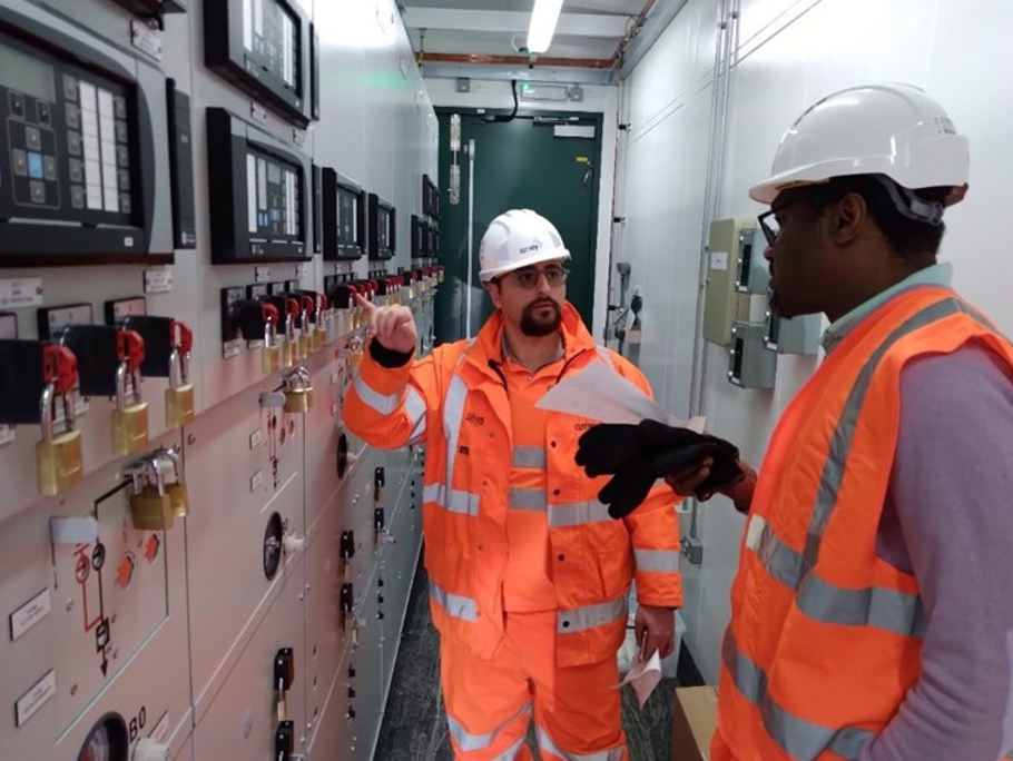 Two Amey employees working within a control room.