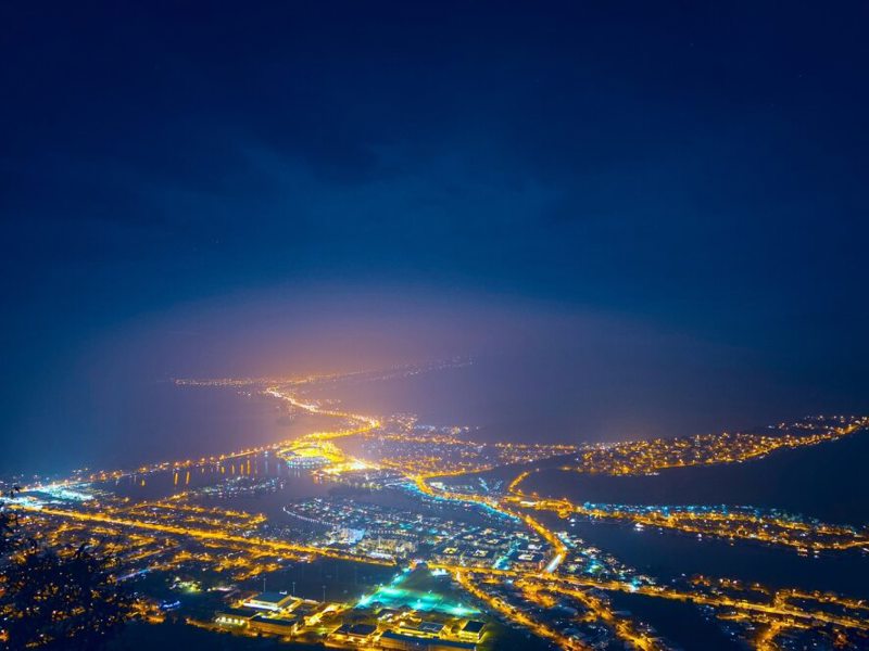 Night time image of a lit up cityscape.