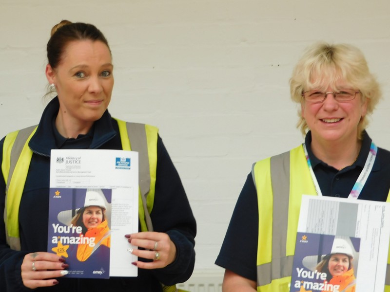 Image of two Amey employees receiving Amey A Stars.