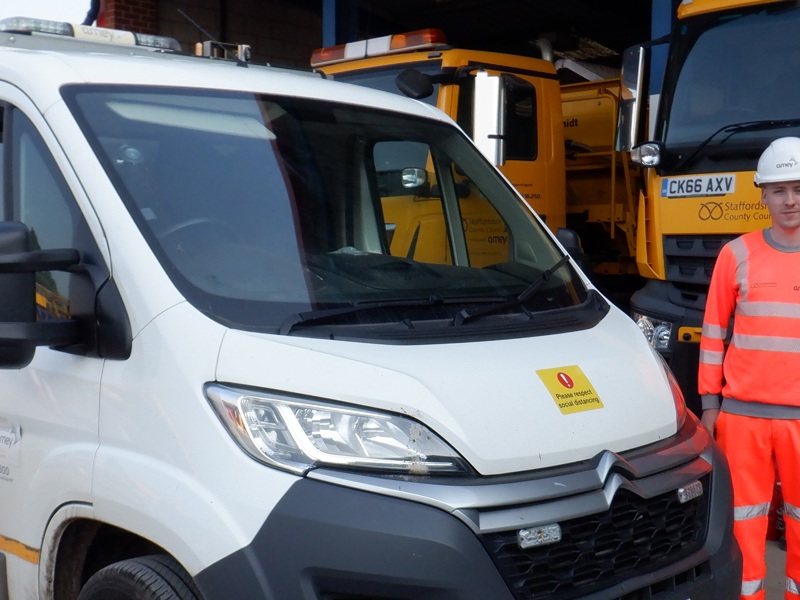 Male Amey employee in PPE stood next to a van.