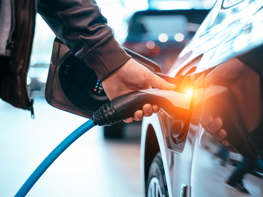 Image of a man placing a charger in an electric car
