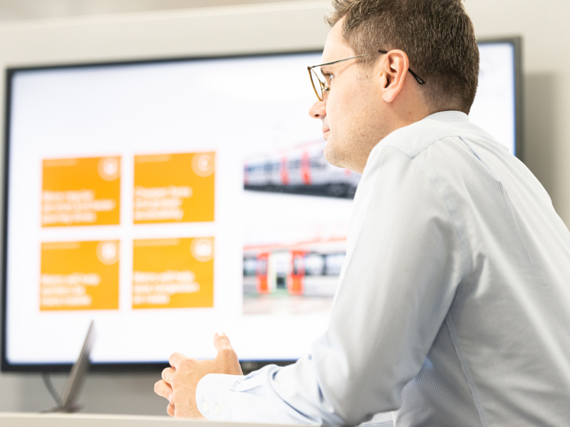 Amey employees in front of a vision board.