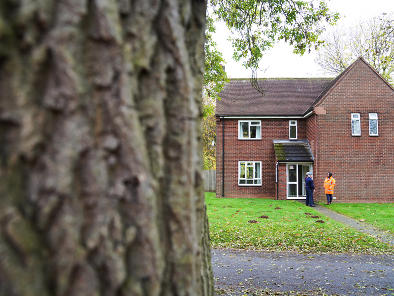 People standing outside a house