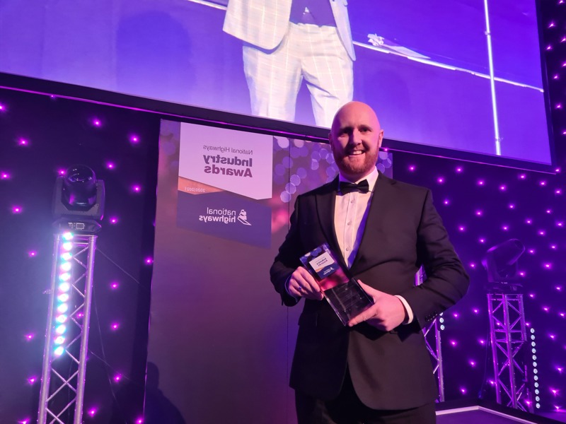 Image of Amey employee holding an award.