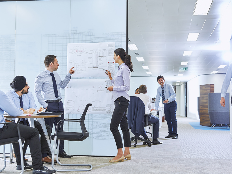 People in an office, working on a project.