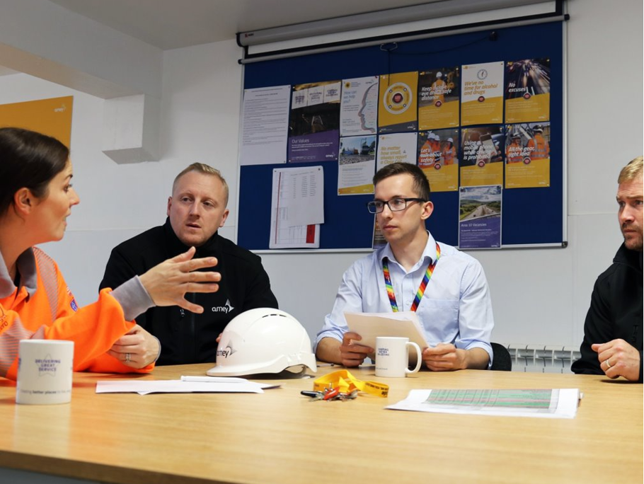 Image of four Amey Employees sitting round a desk