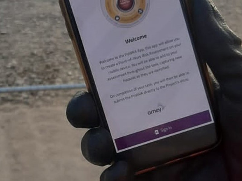 Image of a hand in a glove, holding a mobile.