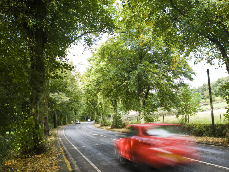 a car at speed on a rural road.