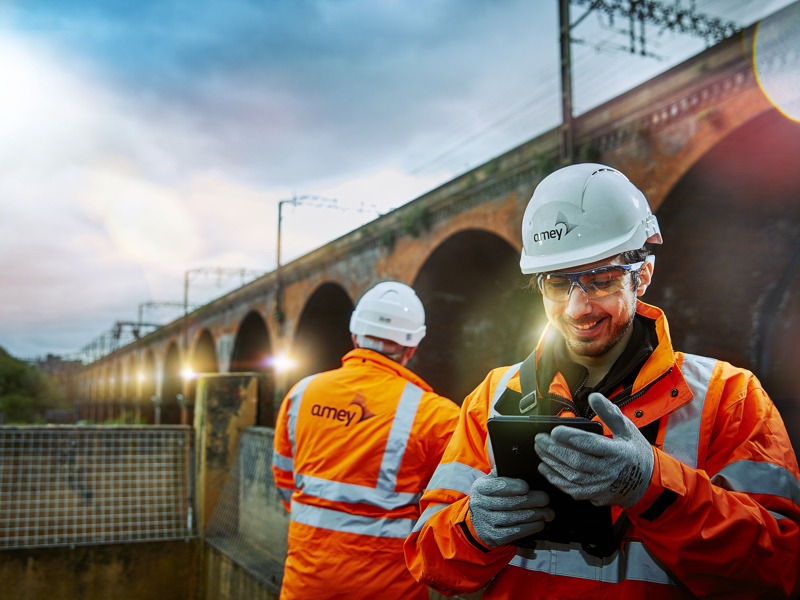 Image of two men in PPE, carrying out a bridge inspection.