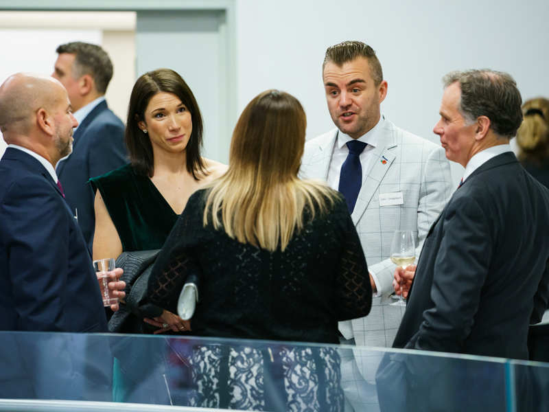 A small gathering of people chatting.