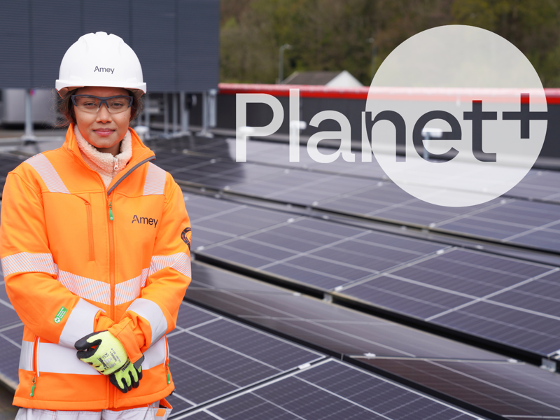 Lady in PPE in front of solar panels