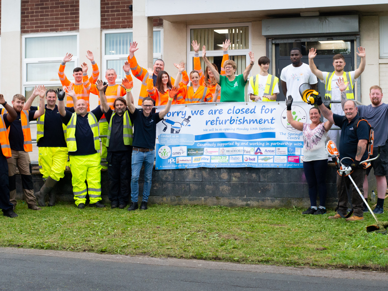 a group of people stood outside a building.