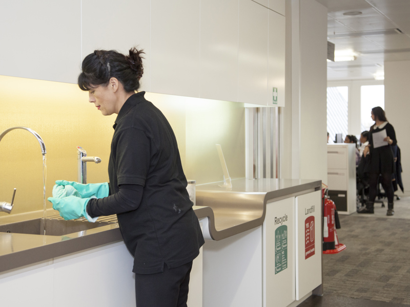 Image of a lady washing up.