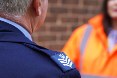 Image of a military man speaking to an Amey employee.