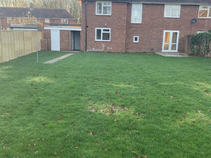 Image of a grassed garden and house.