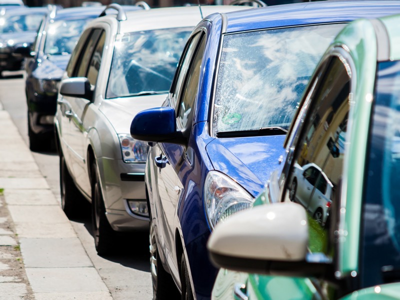 Image of cars parked on a side street.