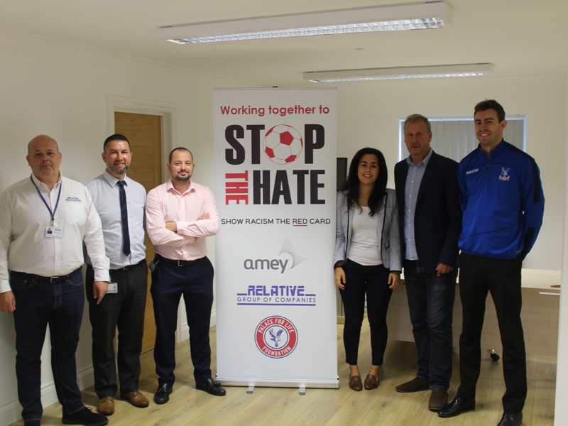 a group of people stood by a banner.
