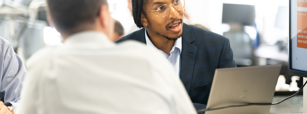 Two men working at a laptop